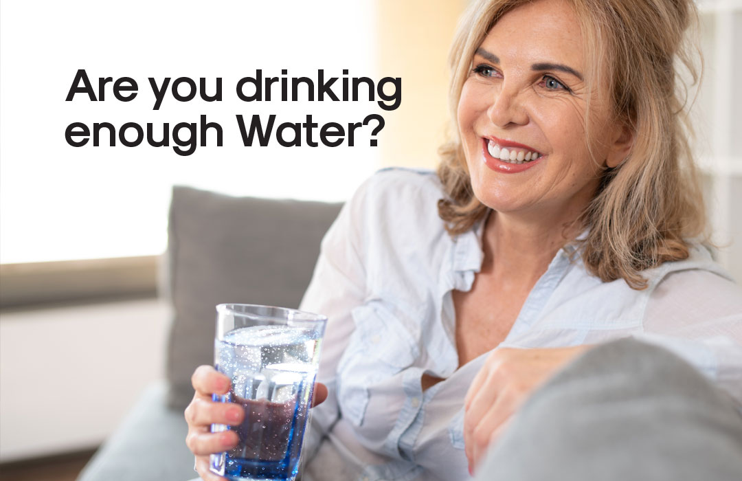 Gorgeous woman drinking a glass of water