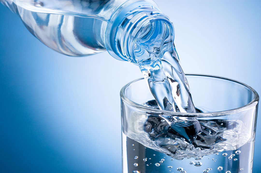 bottled water poured in a glass 