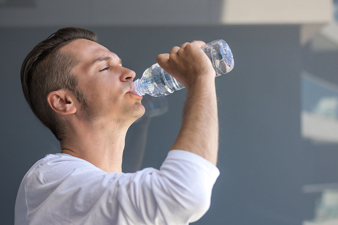 man drinking bottled purified water vs spring water 
