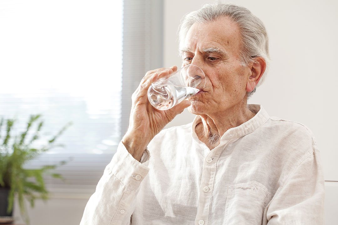 older man drinking boiled water 